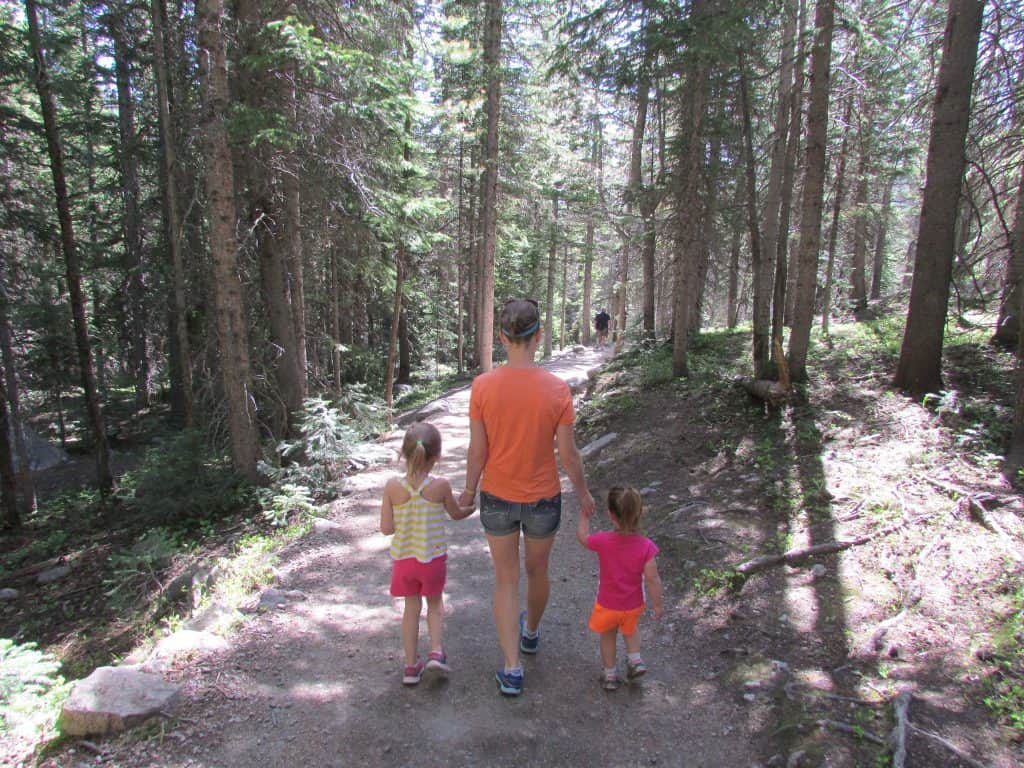 Mom with small children hiking on a trail