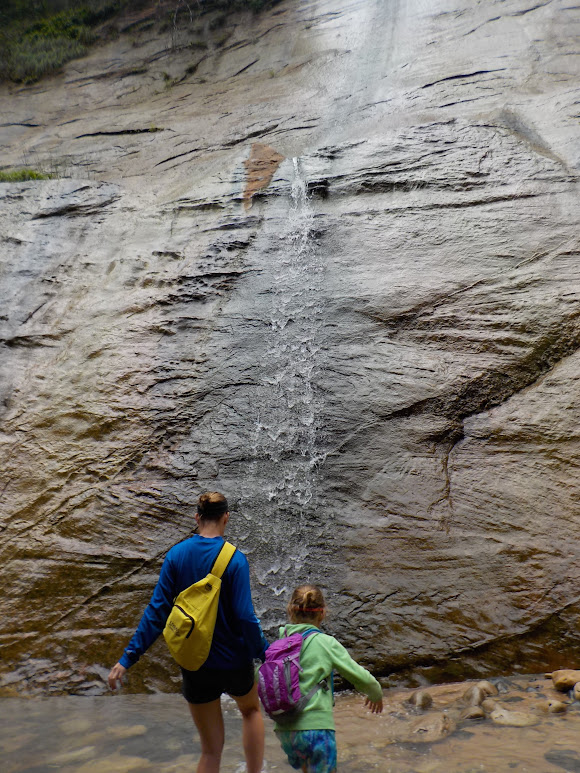 Mother and daughter explore a waterfall in The Narrows in Zion National Park