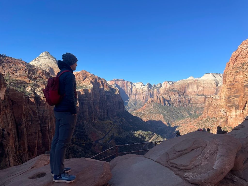 Person enjoying the view of Canyon Overlook Trail, one of the best hikes in Zion National Park
