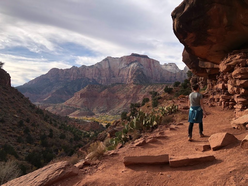 Woman hiking along the Watchman Trail, one of the best trails in Zion National Park