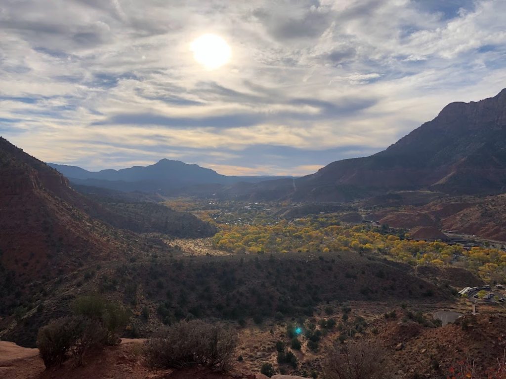a landscape of a valley with mountains and trees