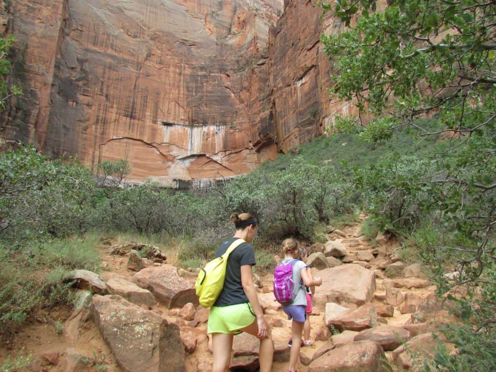Mother and children climb stone steps on Emerald Pool Trail in Zion National Park
