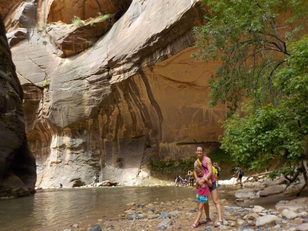 Mother and daughter hike The Narrows in Zion National Park